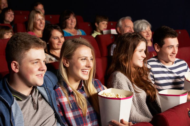 group-of-teenage-friends-watching-film-in-cinema